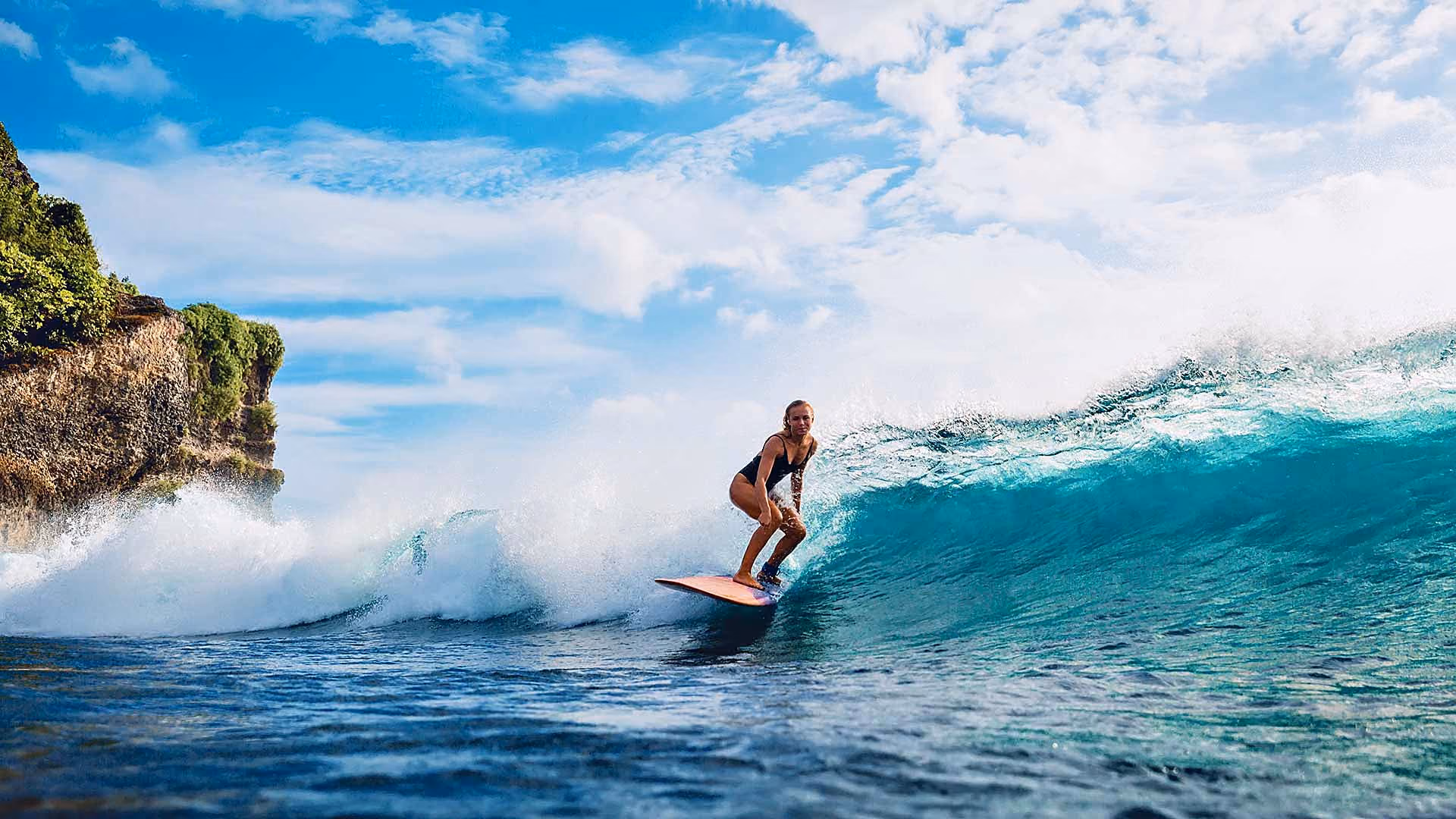 Student surfing a wave in Bali