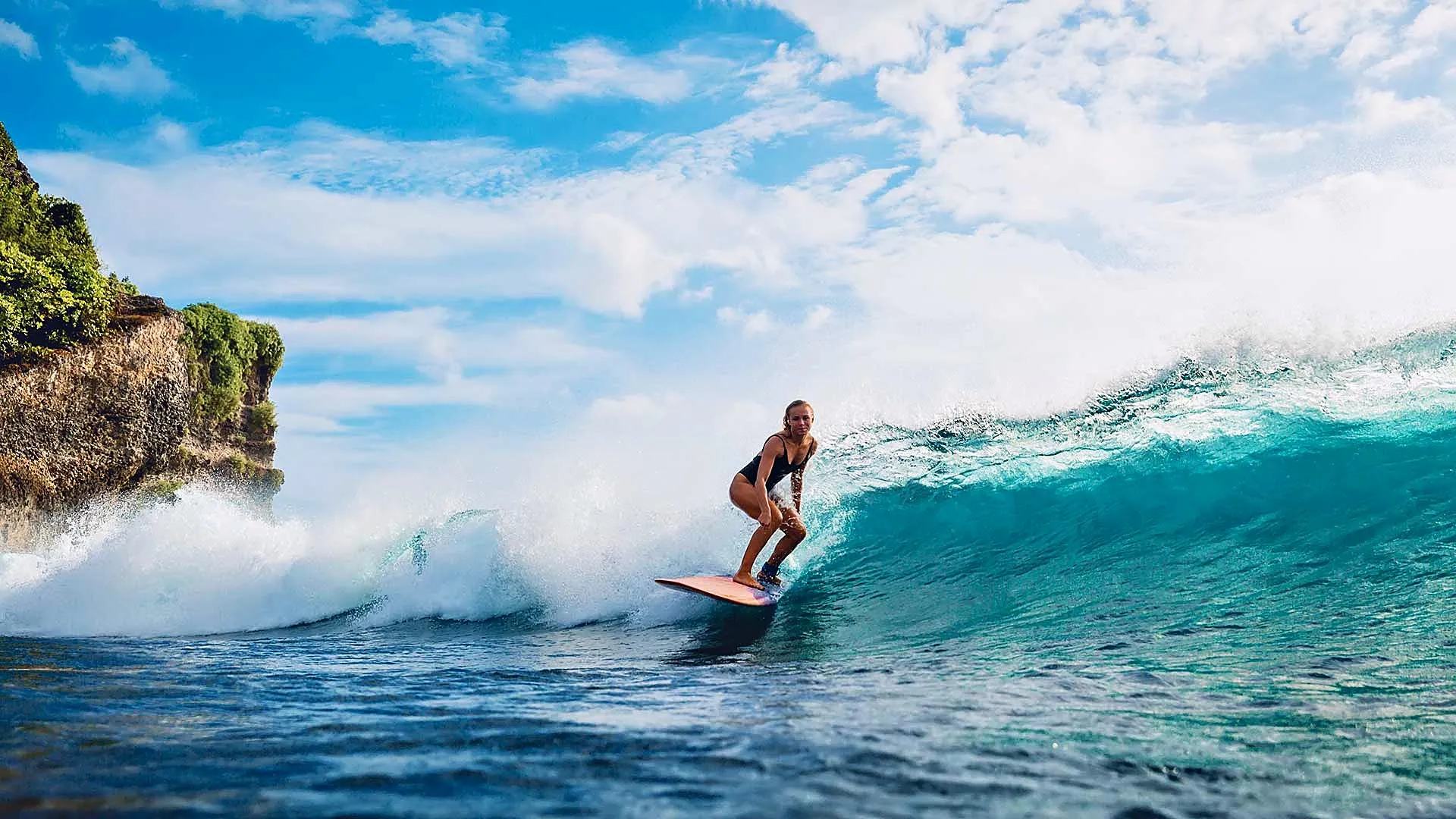 Student surfing a wave in Bali