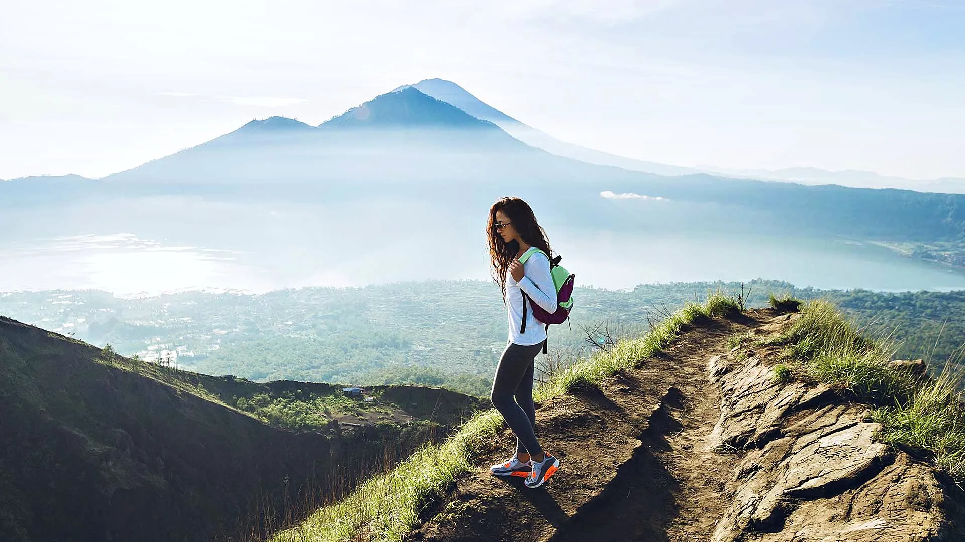 Student hiking on a volcano above the clouds in Bali